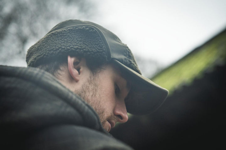 Lifestyle close-up: a man in a fleece-lined cap wearing the Seeland Canada Yukon jacket, seen in profile leaning forward