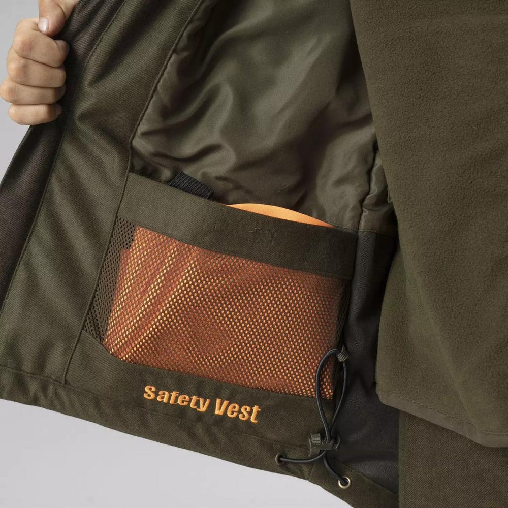 Detail shot of the jacket held open to reveal an internal mesh pocket holding a folded orange safety vest, embroidered 'Safety Vest', beside the drawcord hem.