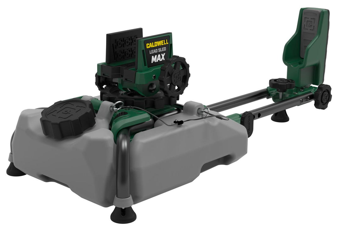 Caldwell Lead Sled Max shooting rest in green and grey, three-quarter view showing the grey weight tray, front rifle cradle with elevation wheel and the rear buttstock support on a sliding rail