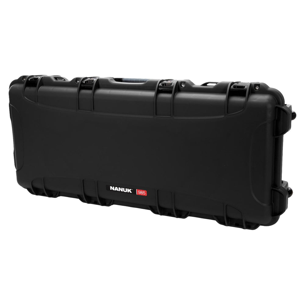 NANUK 985 hard case closed, three-quarter view showing the long lid profile, PowerClaw latches, carry handle and integrated wheels at one end.
