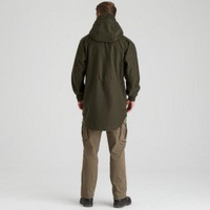 Rear view of a model wearing the Ridgeline Monsoon Classic Smock in Deep Forest green with the hood up, showing the long drop-tail hem