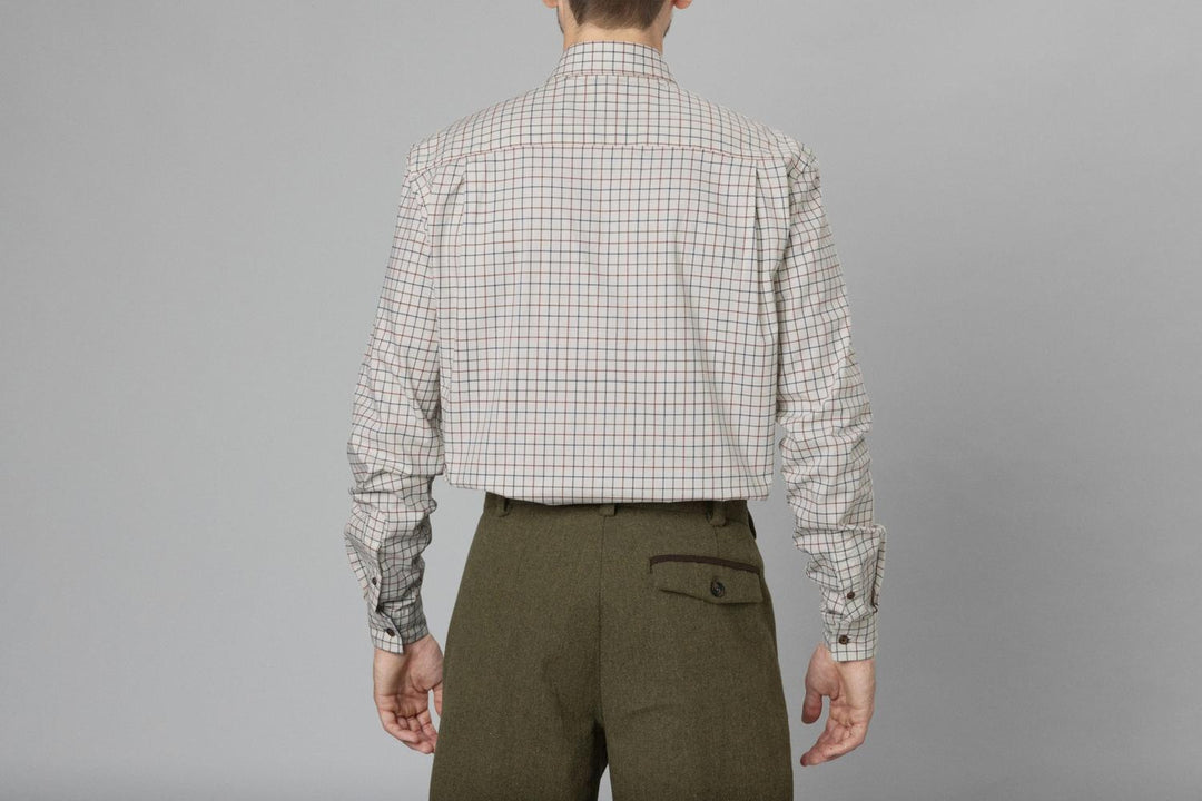 Rear view of a model in the Seeland Oxford check shirt and olive tweed breeks, torso and arms