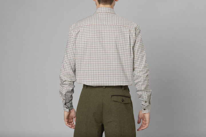 Rear view of a model in the Seeland Oxford check shirt and olive tweed breeks, torso and arms