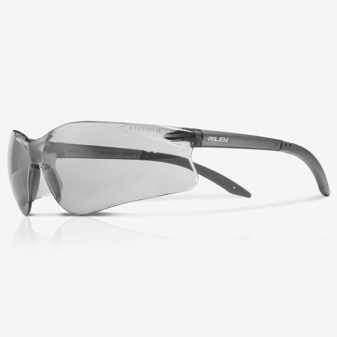 Riley Fabri safety glasses with grey tinted lens and grey arms, side view on a plain background