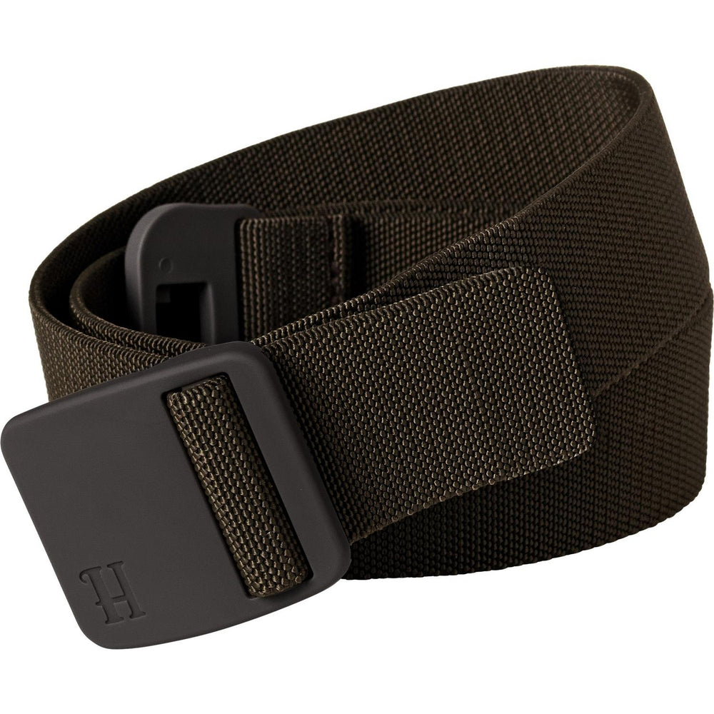 Harkila Tech belt in olive stretch webbing shown coiled from a slightly different angle, the low-profile moulded buckle and H-branded end tab in the foreground.