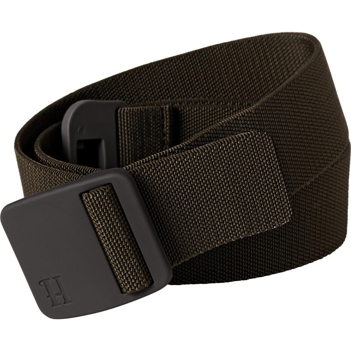 Harkila Tech belt in olive stretch webbing shown coiled from a slightly different angle, the low-profile moulded buckle and H-branded end tab in the foreground.