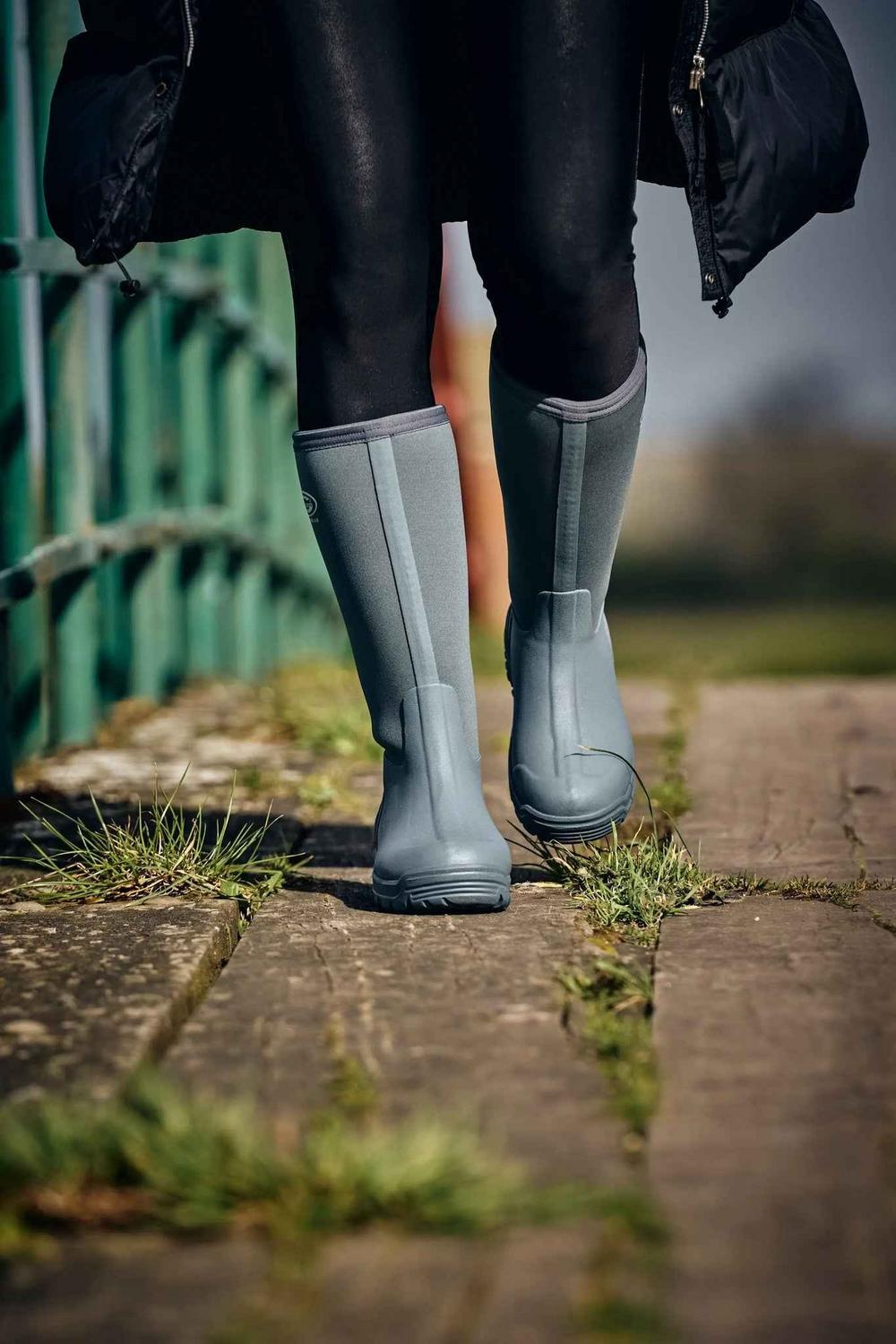 Grey Grubs Frostline 5.0 insulated wellington boots worn walking on a wooden boardwalk