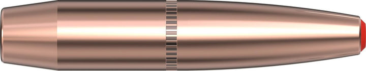 Hornady 307gr SUB-X .338 bullet lying horizontally, copper jacket with knurled cannelure and red Flex Tip polymer point, side view