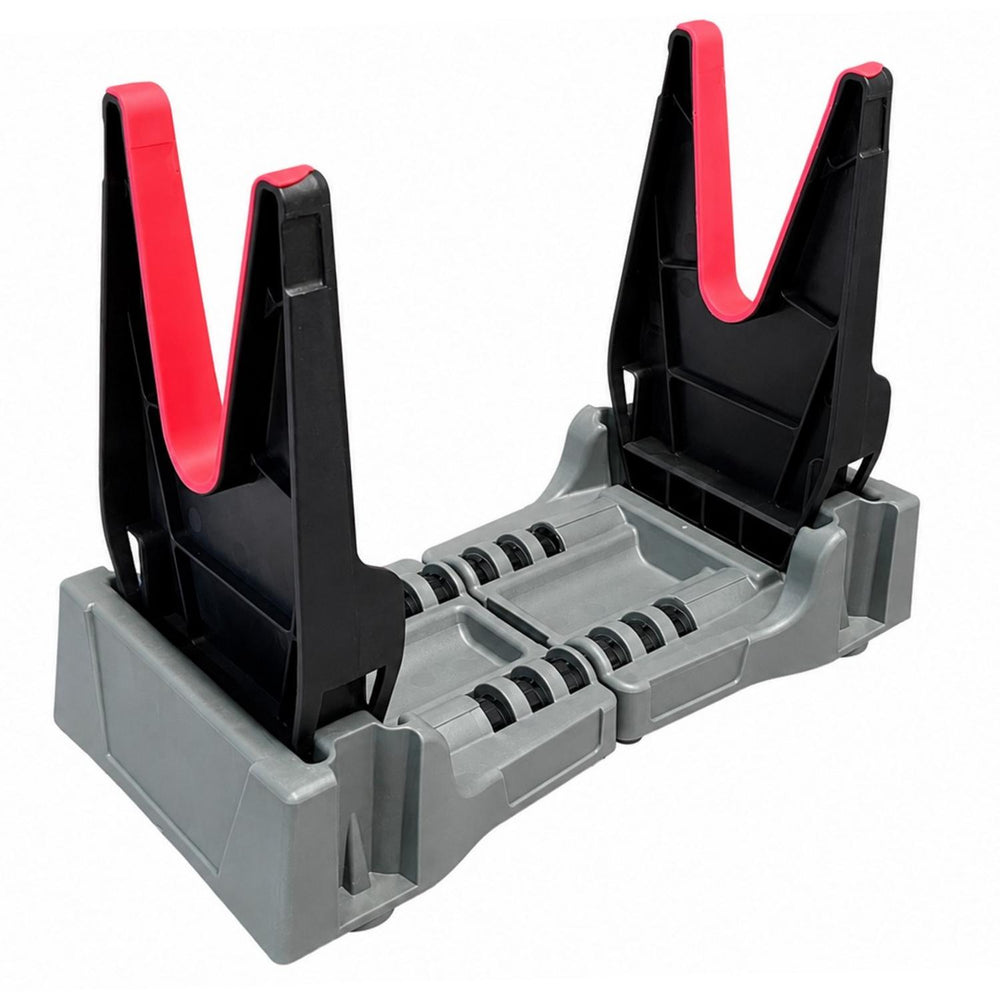 Mjoelner cleaning cradle standing empty, grey base with two black uprights and red padded V-jaws, front three-quarter view
