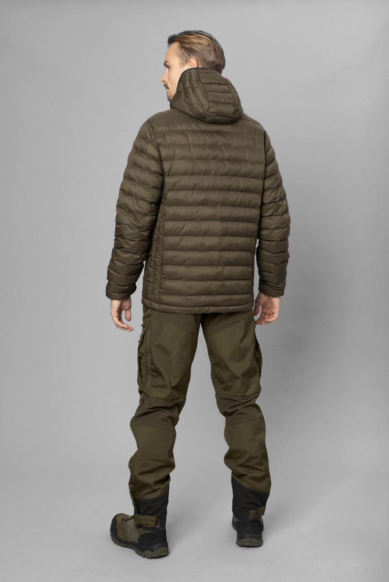Model wearing the Fahrenheit jacket, full-length rear view with the hood down over the quilted back