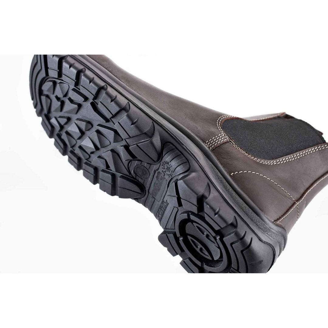 Grubs Tempest dealer boot angled to show the underside of the black treaded sole and brown leather upper