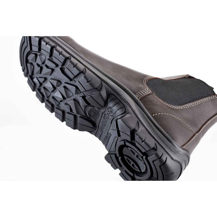 Grubs Tempest dealer boot angled to show the underside of the black treaded sole and brown leather upper