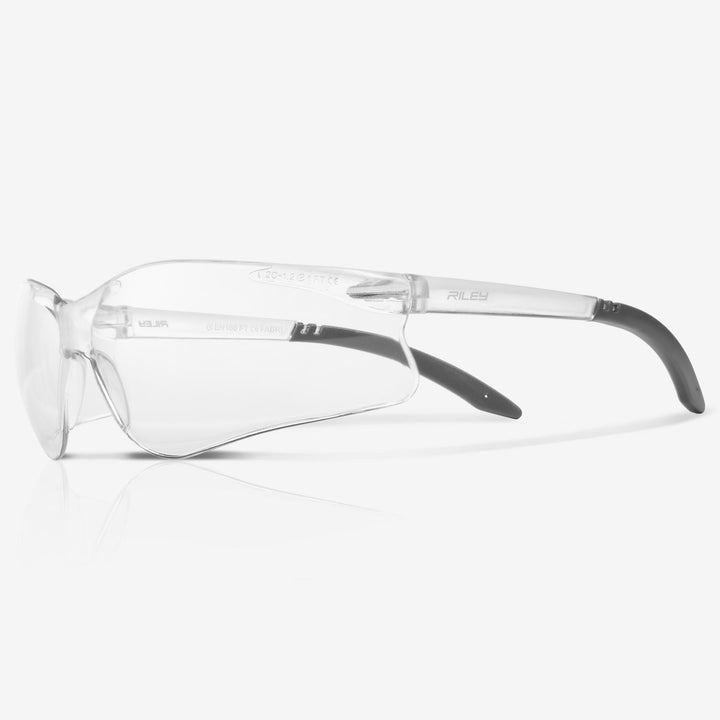 Riley Fabri safety glasses with clear lens and grey arm tips, side view on a plain background