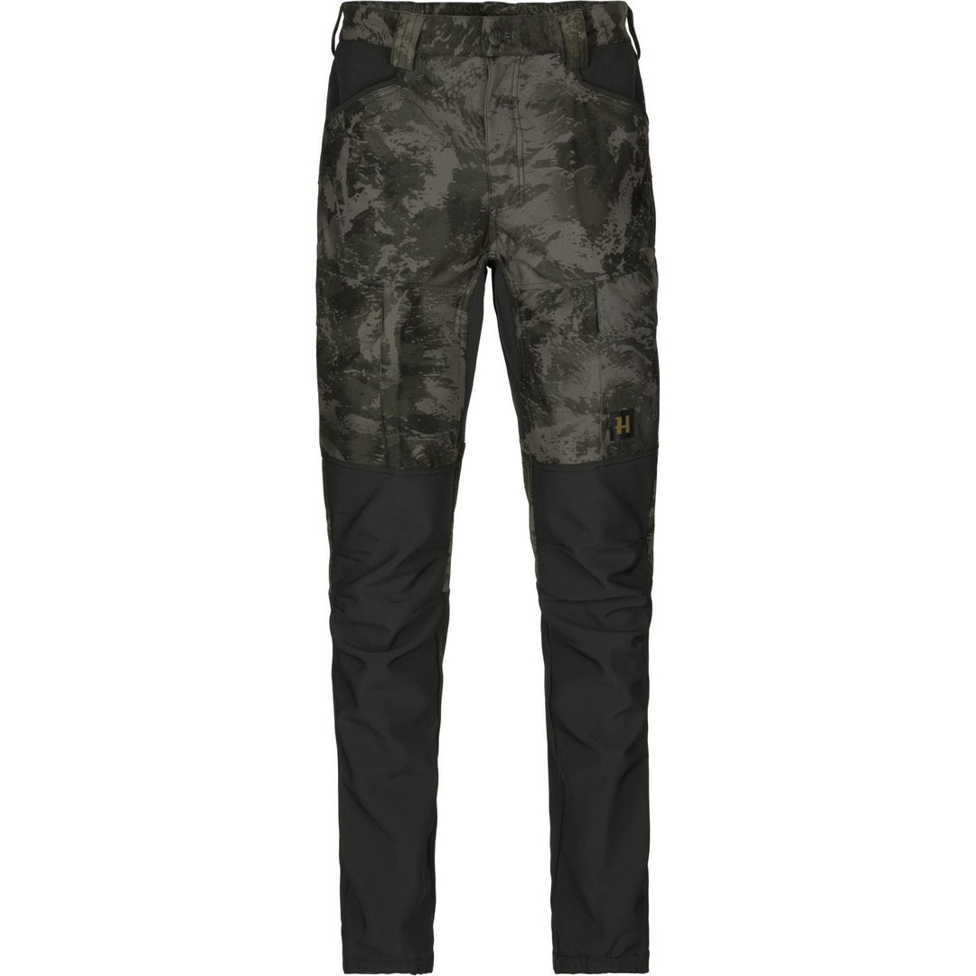 Harkila NOCTYX silent trousers in dark AXIS camo with black stretch knee and lower-leg panels, front-on and cut out on white