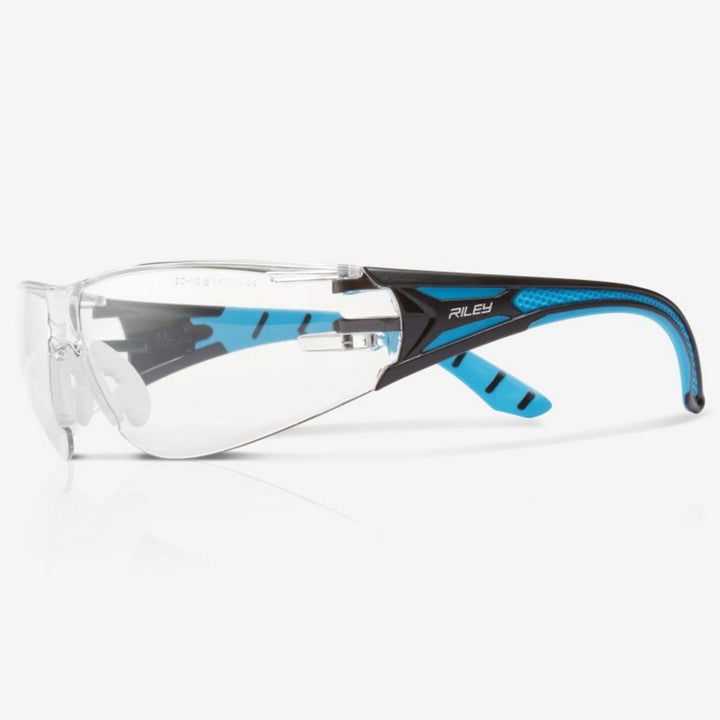 Riley Stream Blue safety glasses with clear lens, black and blue frame, side view with Riley name on the arm