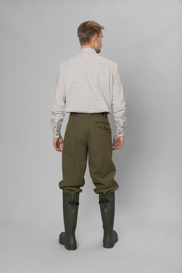 Full-length rear view: model in Seeland Oxford check shirt, olive tweed breeks and green wellingtons