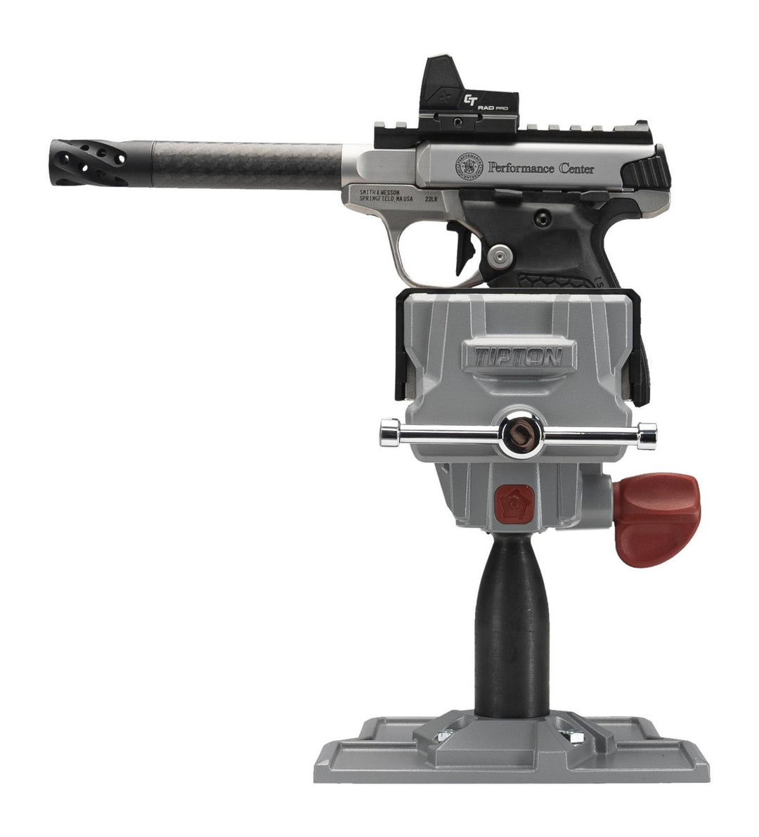Tipton Best Gun Vise 360, grey clamp head with red rubber jaws on a black pedestal and grey star-shaped base, shown from the side gripping a Performance Center pistol fitted with a red dot