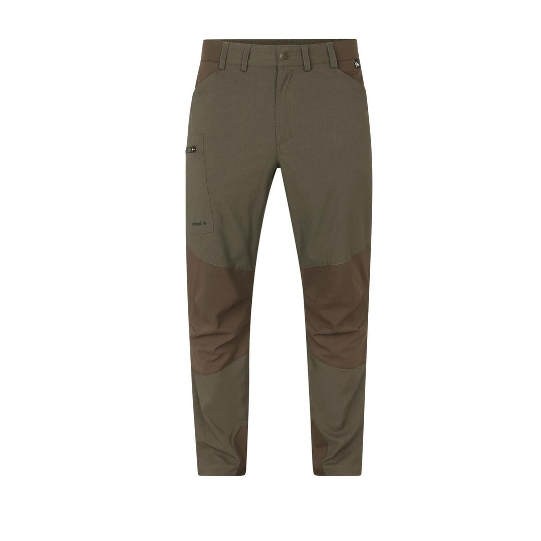 Seeland Ash outdoor trousers in olive green with darker brown reinforced seat and lower-leg panels, front view laid flat with belt loops and hand pockets.