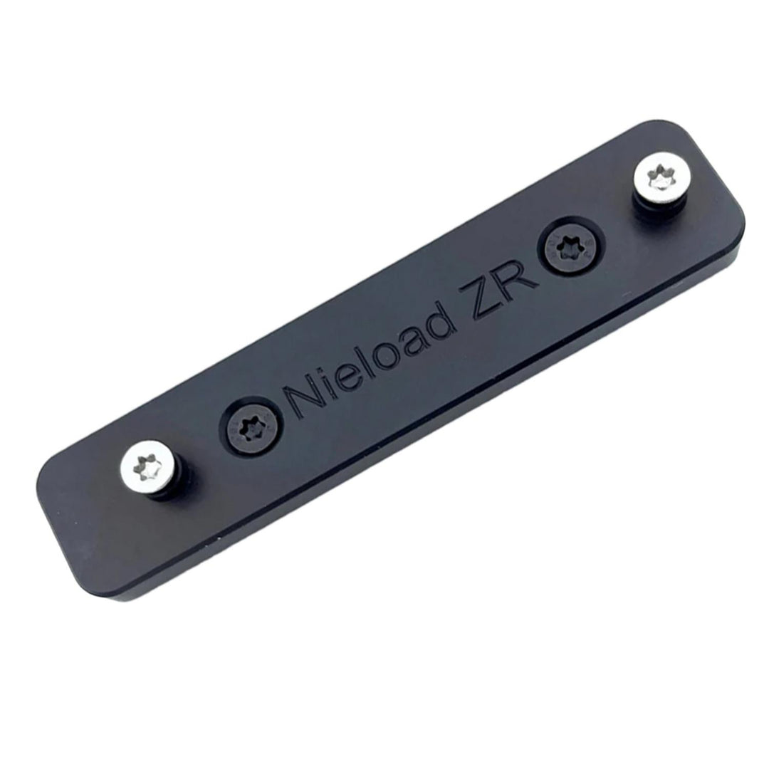 Nieload Zeiss ZR rail adapter, flat black anodised plate engraved 'Nieload ZR' with two Torx fixing screws, three-quarter view on white