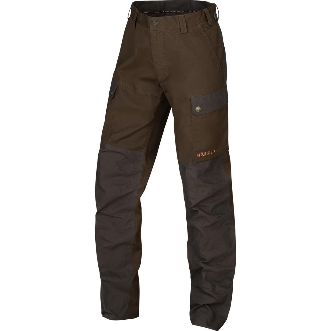 Harkila Asmund trousers seen front-on, olive-brown with darker contrast knee and lower-leg panels, buttoned thigh pocket, belt loops and a D-ring at the waist.