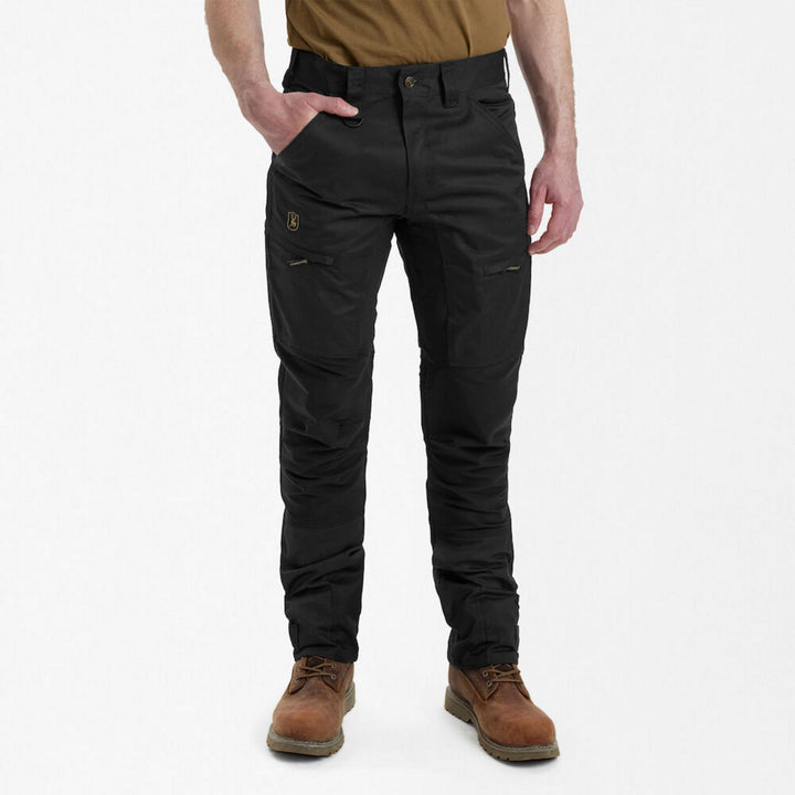 Deerhunter Rogaland Stretch Trousers Contrast Black on a model, front view with hand in pocket, showing the knee panel and thigh zip pocket