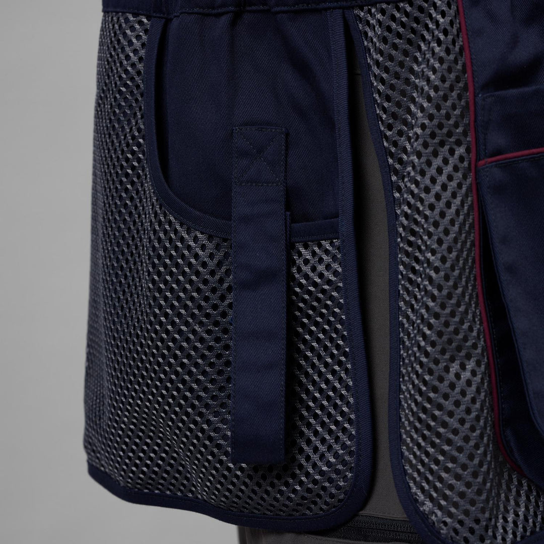 Close-up of the Skeet II waistcoat's navy shoulder recoil pad and open mesh body panel with red piping