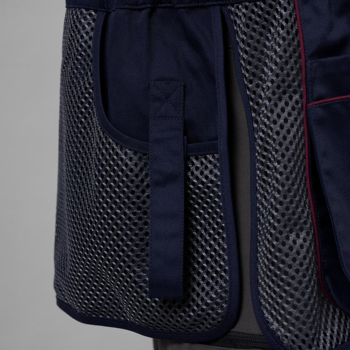 Close-up of the Skeet II waistcoat's navy shoulder recoil pad and open mesh body panel with red piping
