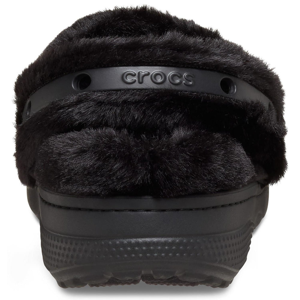 Rear close-up of the black furry Unfurgettable Crocs clog, showing the CROCS wordmark on the strap under the fur collar