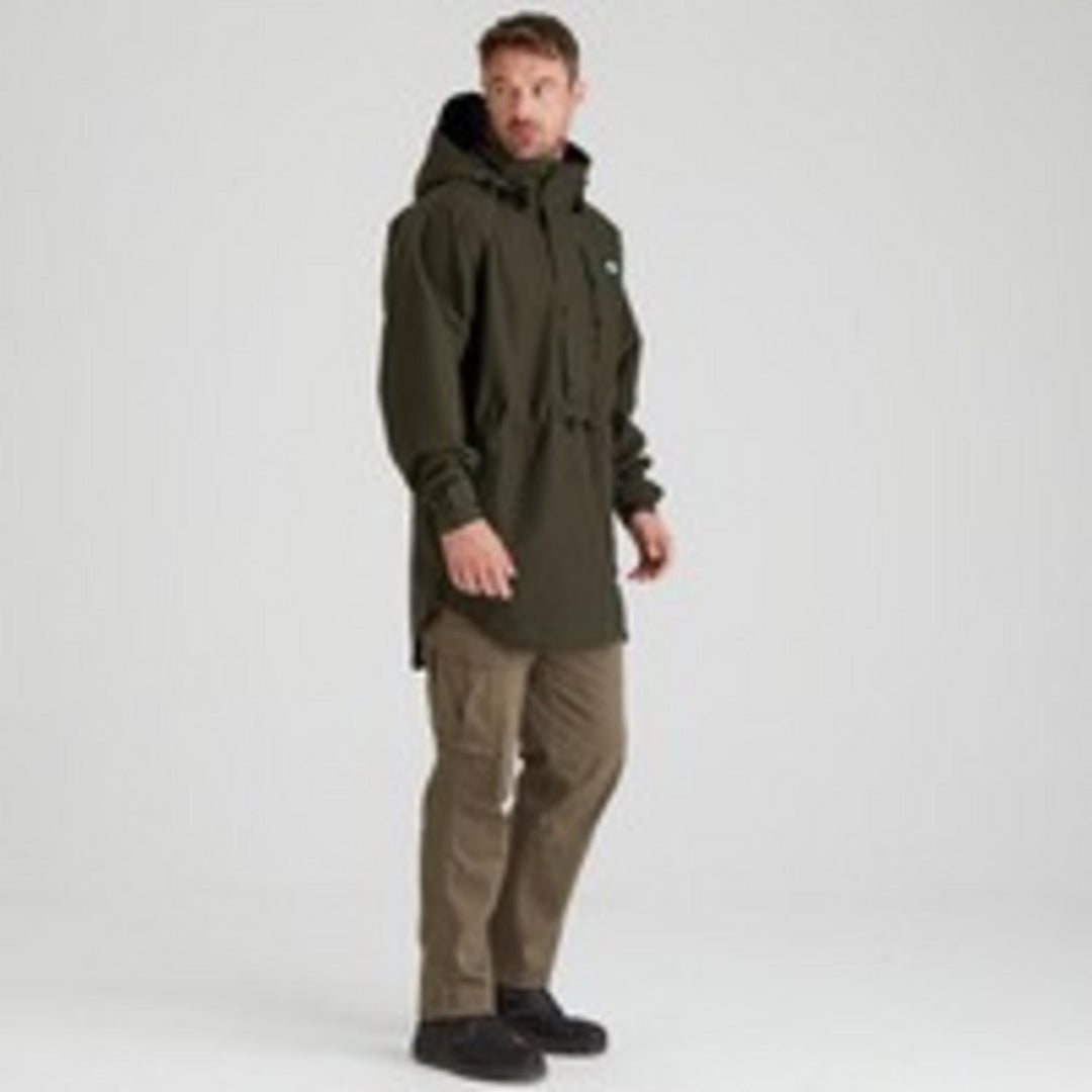 Model in the Ridgeline Monsoon Classic Smock, Deep Forest green, three-quarter front view with hood up and hands in the front hand-warmer pockets