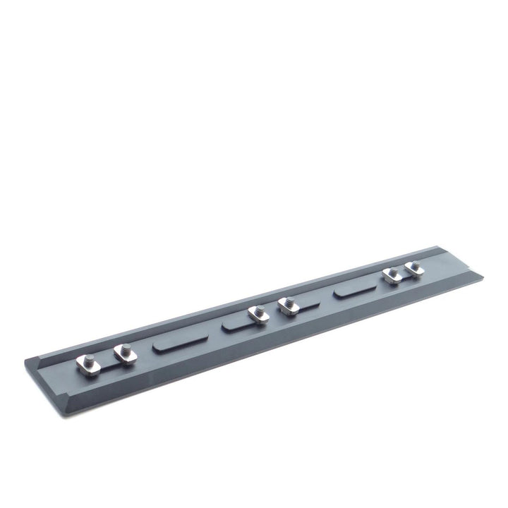 Nieload ARCA forend rail seen from above at an angle, showing the slotted profile and the silver clamping nuts