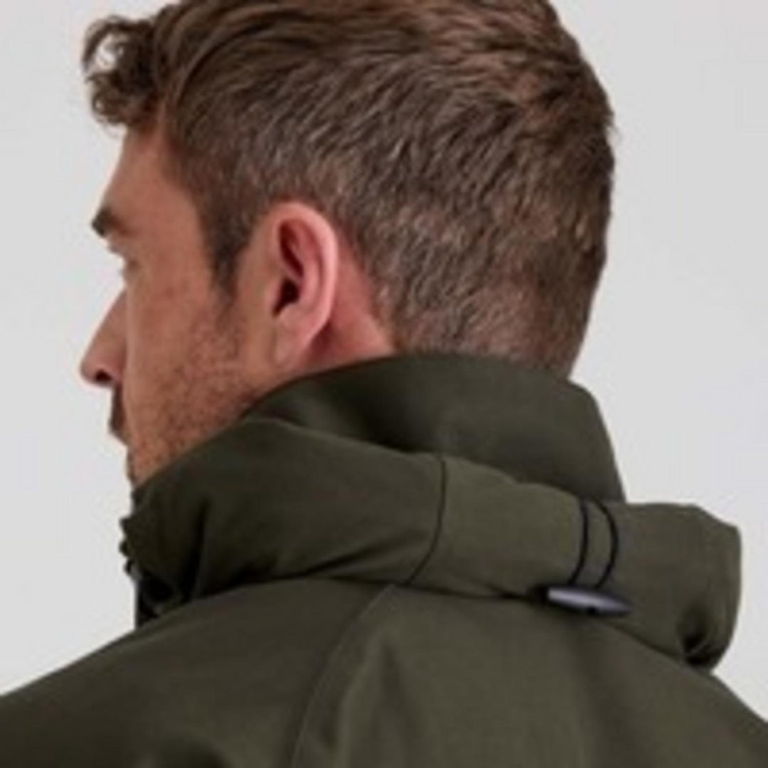 Close-up of the Ridgeline Monsoon Classic Smock hood in Deep Forest green, worn by a model in profile, showing the hood collar and toggle drawcord