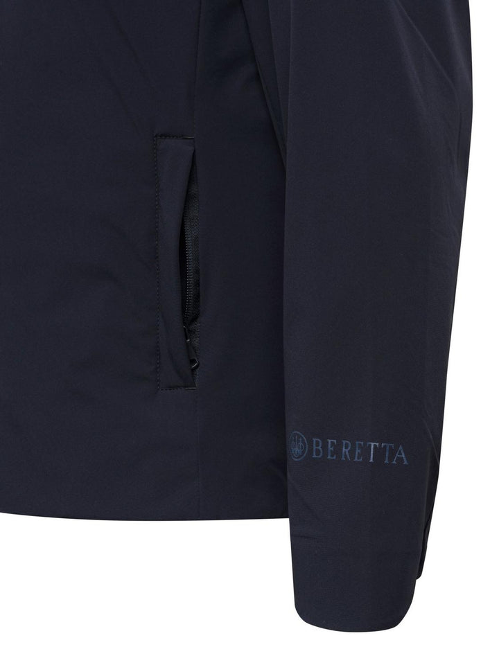 Beretta Pursuit 2 in 1 Jacket in navy blue, close-up of the zip pocket and Beretta logo on the sleeve