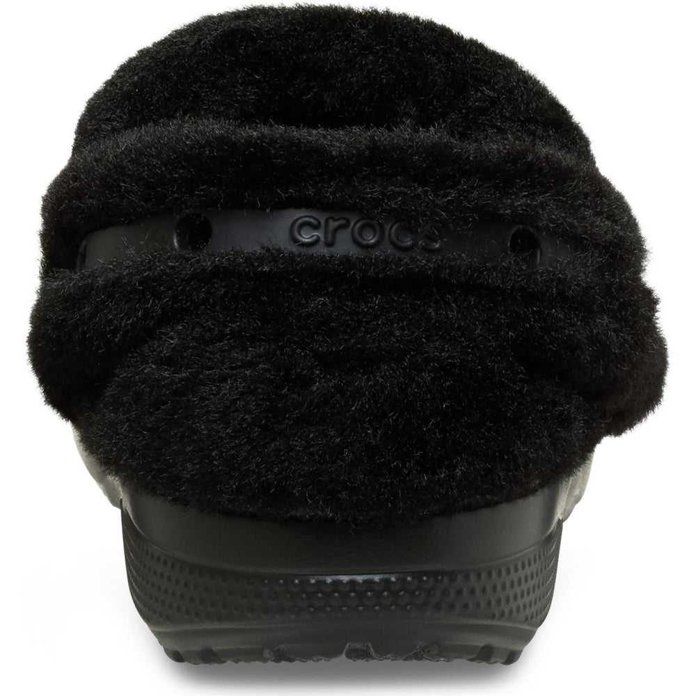Rear close-up of the black Unfurgettable Crocs clog, showing the embossed crocs strap beneath a deep black faux-fur collar