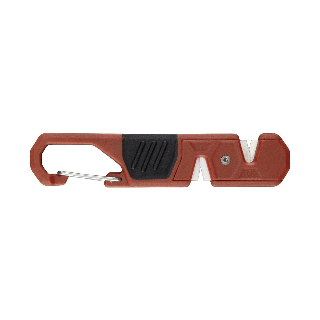 Gerber Edgefield pocket knife sharpener in burnt orange, side view of the slim carabiner-shaped body with a black grip pad and the V-shaped sharpening slot