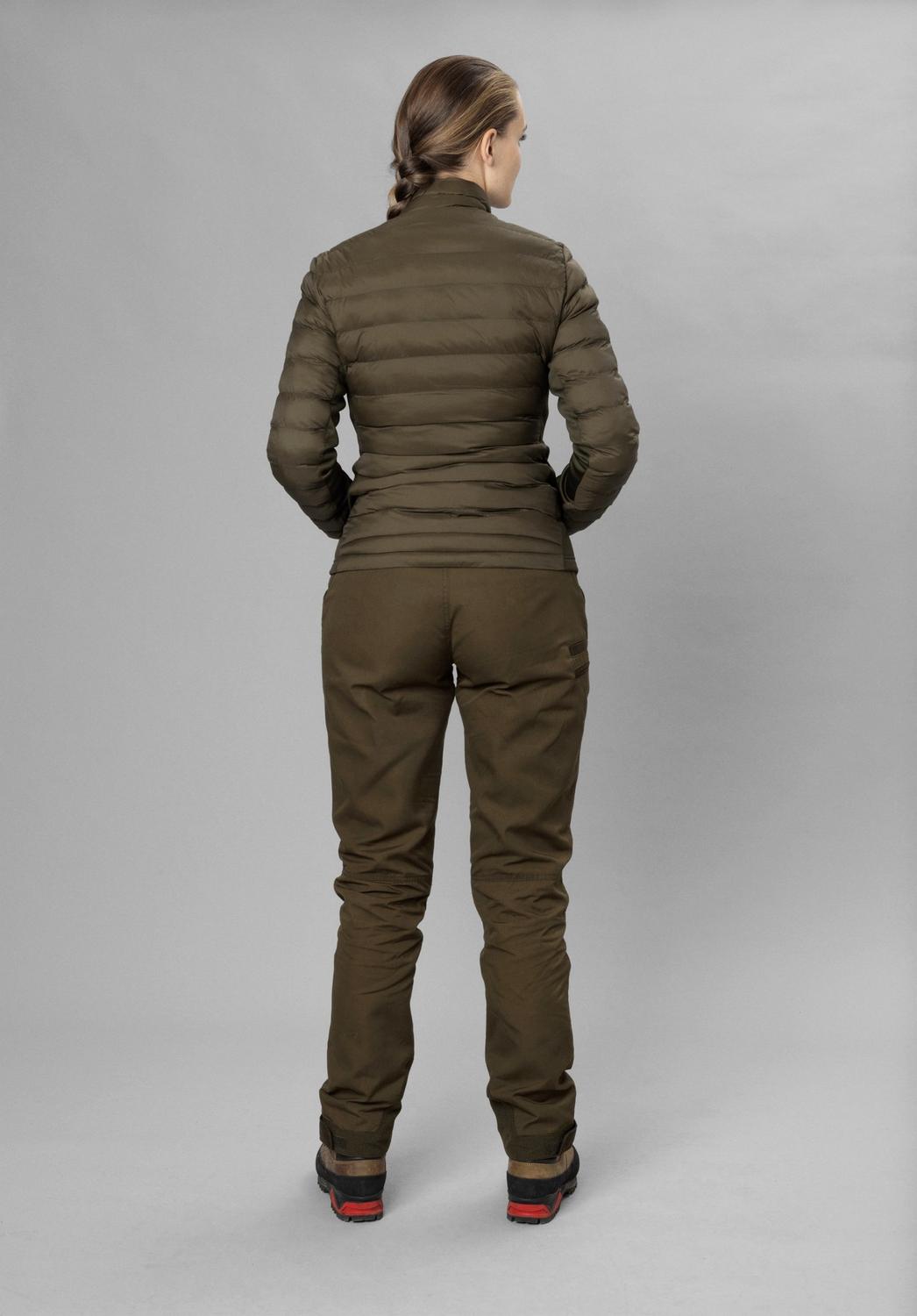 Full-length rear view of a model in the olive Seeland Therma Puffer Jacket with matching olive trousers and boots, grey studio backdrop.