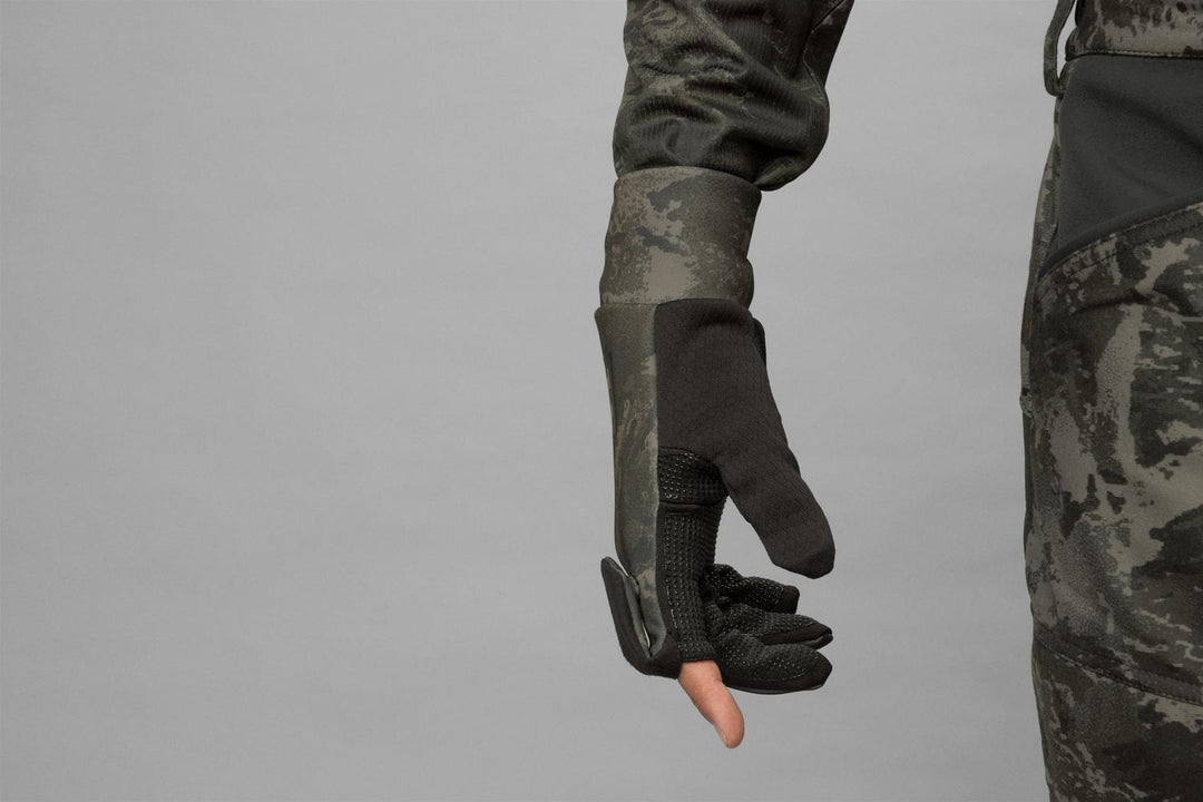 Detail shot of the glove with the index fingertip folded back and studded down, leaving the bare finger exposed for trigger feel.