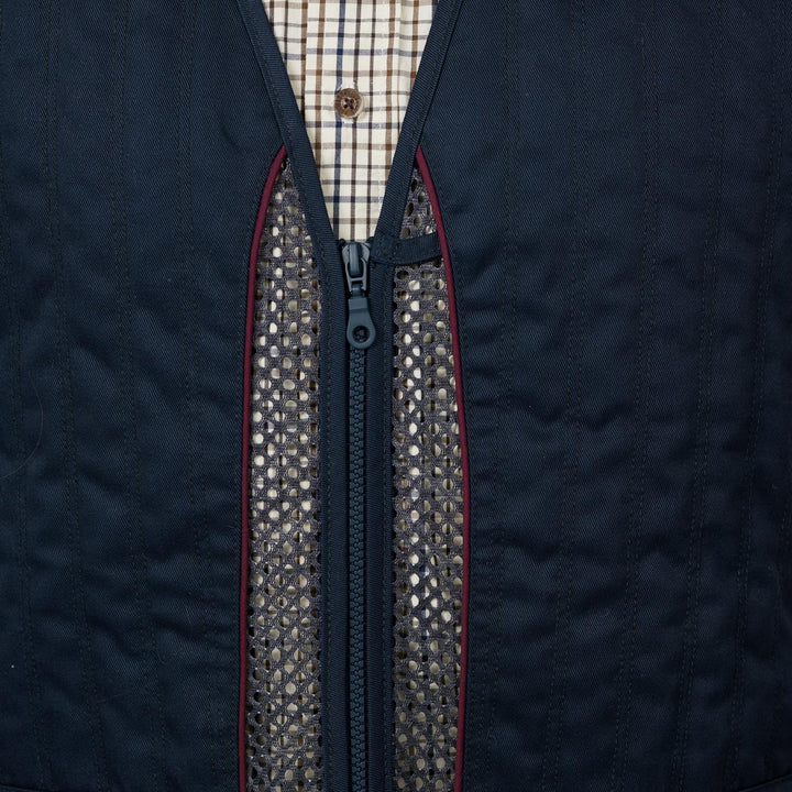 Close-up of the Skeet II front zip with red piping and mesh body fabric either side