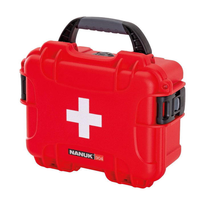 Nanuk 904 waterproof first aid case in red, closed, three-quarter front view showing the white cross, black carry handle and side latches