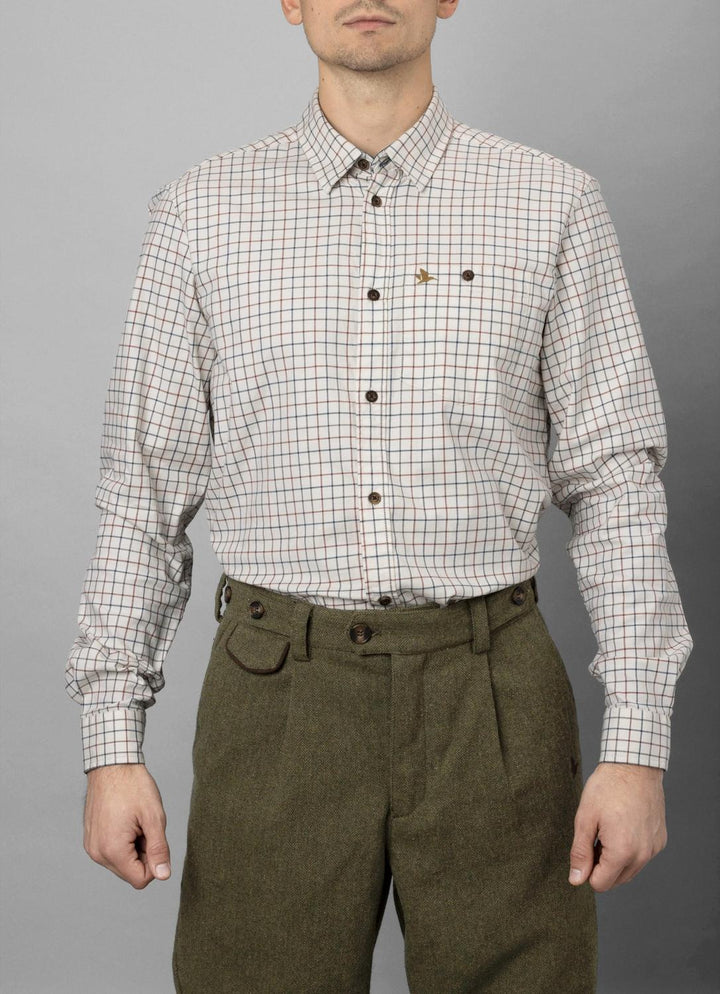 Man wearing the Seeland Oxford check shirt with olive tweed breeks, torso-down front view on grey backdrop