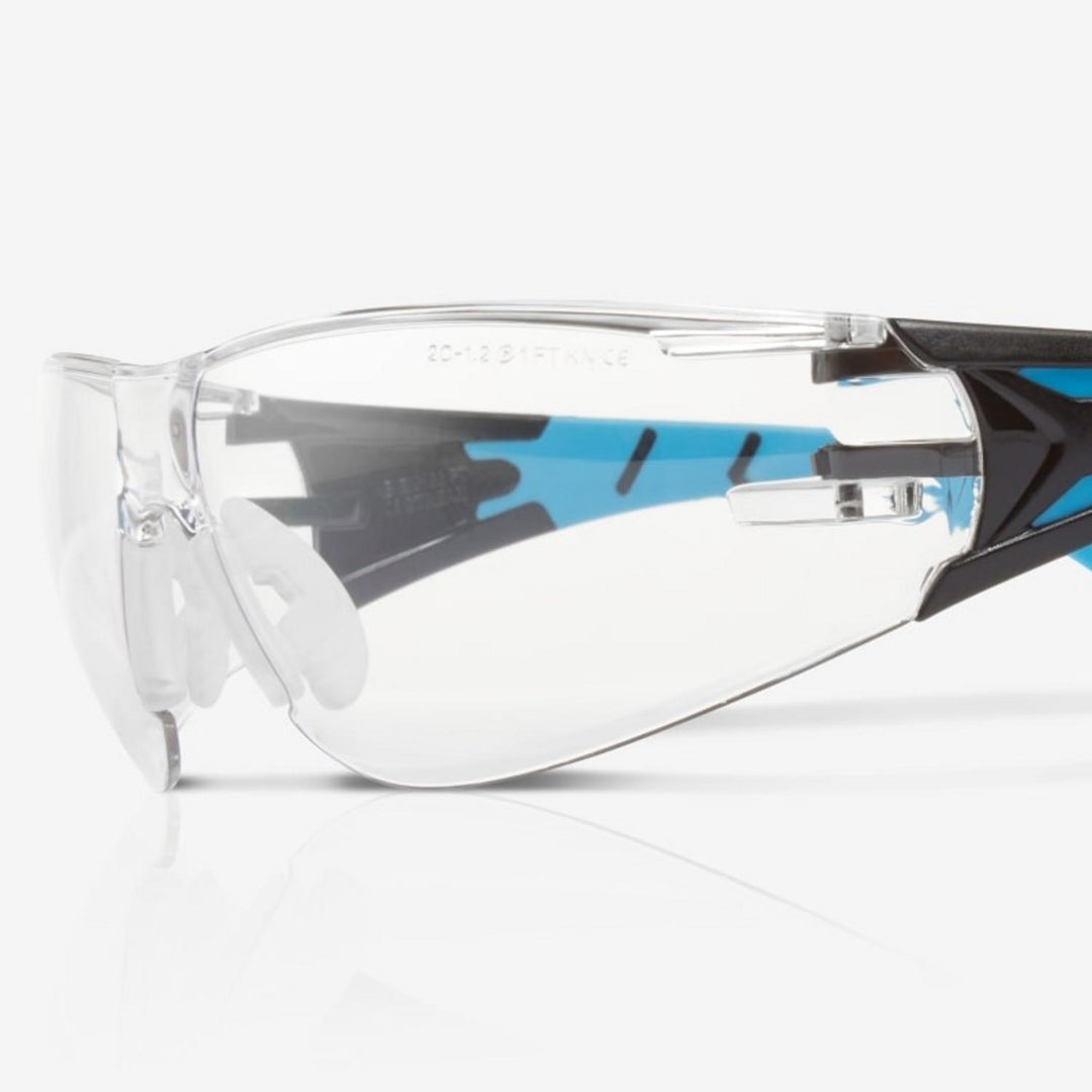 Riley Stream Blue safety glasses with clear lens, close-up three-quarter view of the lens and hinge