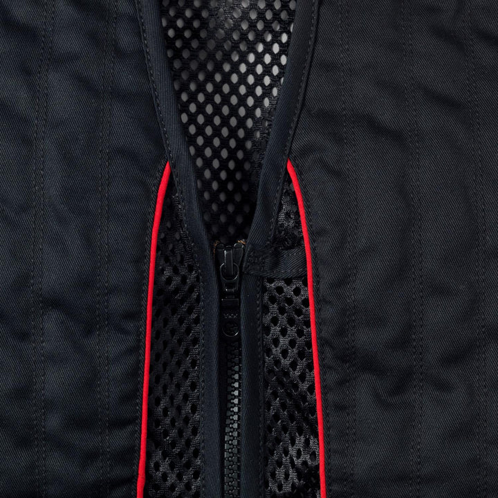 Close-up of the Skeet II front zip, with red piping running either side of the quilted recoil shoulder panel