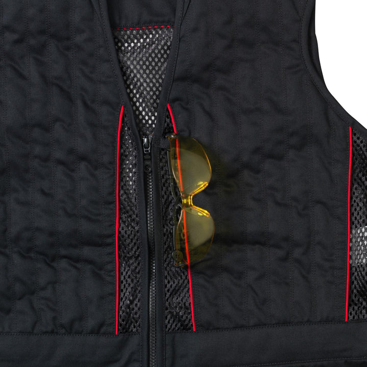 Yellow-lensed shooting glasses tucked into the chest pocket of the black Skeet II waistcoat