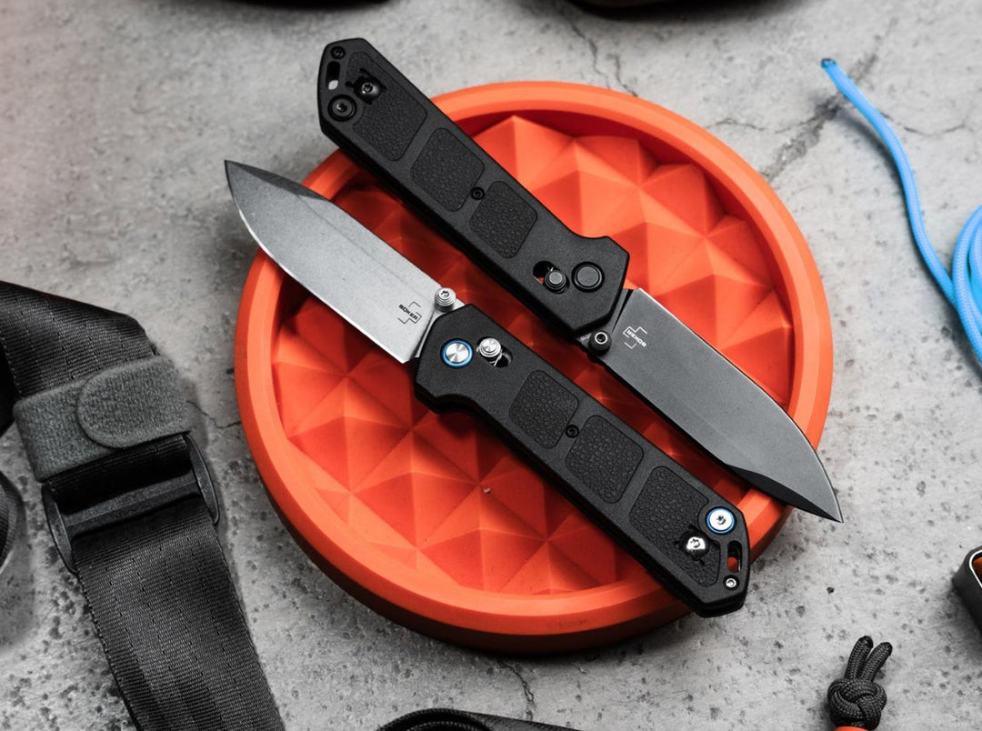Böker Plus Kihon DC 2.0 knives with black handles lying on an orange studded tray with blue cord, lifestyle shot