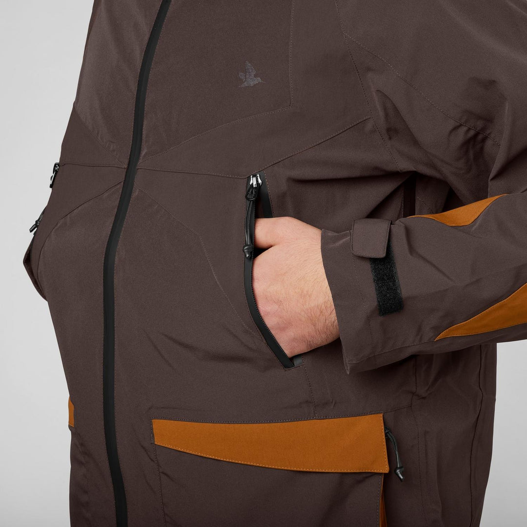 Close-up of a hand in the tan lower pocket of the Seeland Dog Active jacket, side view