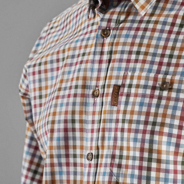 Close-up of the buttoned chest pocket and Härkila label on the multi-check Milford shirt