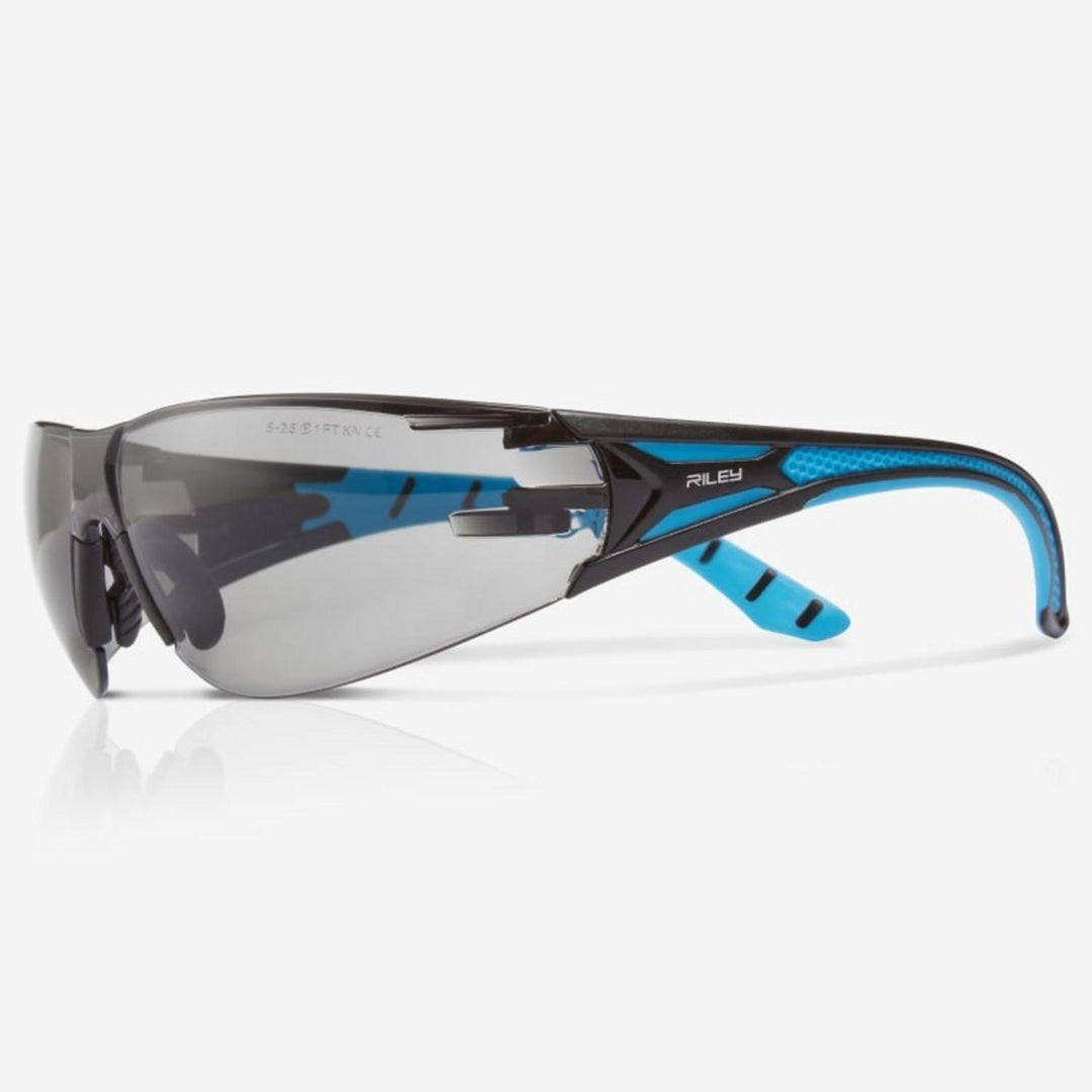 Riley Stream Blue safety glasses with grey lens, black and blue frame, side view with Riley name on the arm