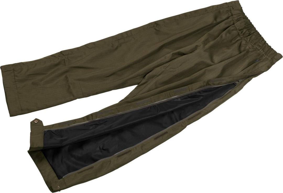 Seeland Buckthorn overtrousers laid on their side with one leg zip opened to show the dark waterproof membrane lining inside