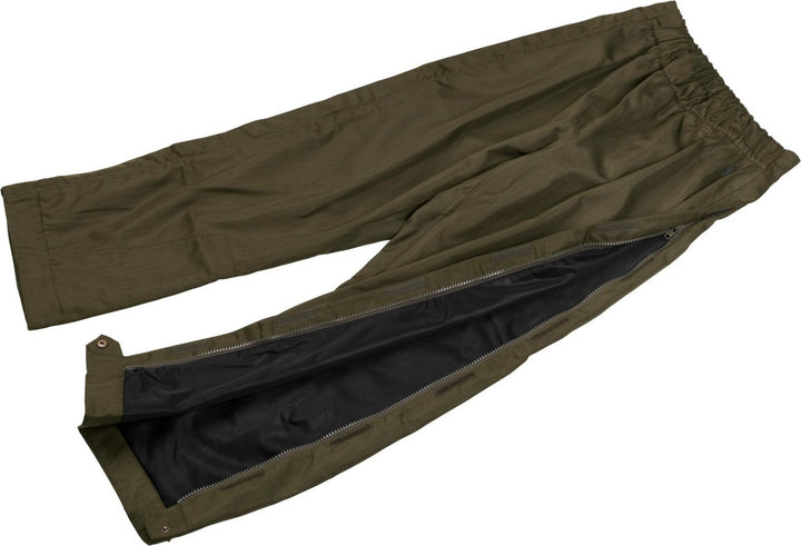 Seeland Buckthorn overtrousers laid on their side with one leg zip opened to show the dark waterproof membrane lining inside