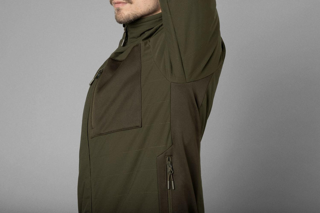 Side detail on a model showing the olive jacket shoulder, chest pocket and lower zipped hand pocket.