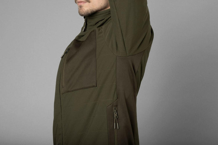 Side detail on a model showing the olive jacket shoulder, chest pocket and lower zipped hand pocket.